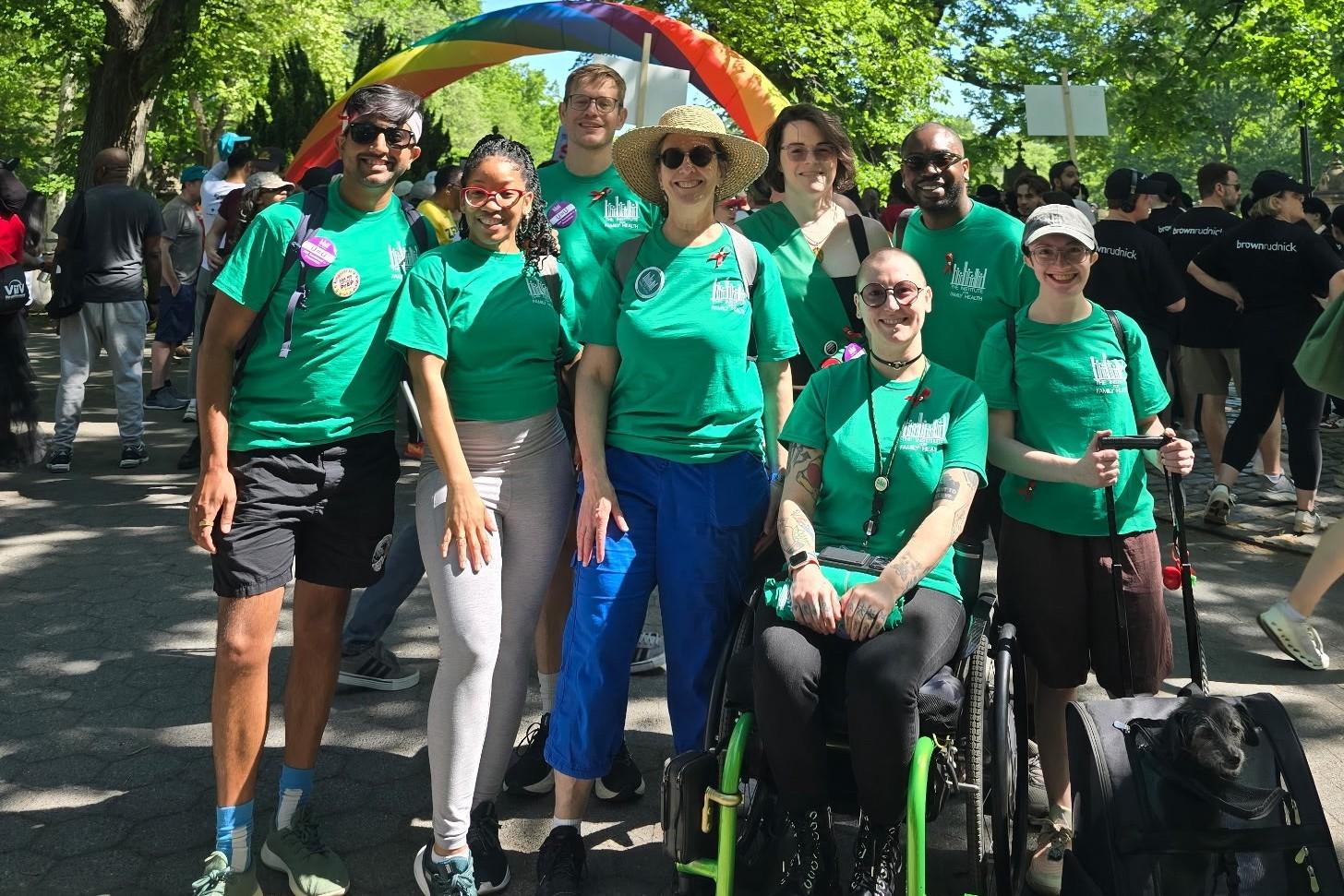 A row of Institute for Family health staff dressed in matching green t-shirts at the AIDS Walk in New York City.